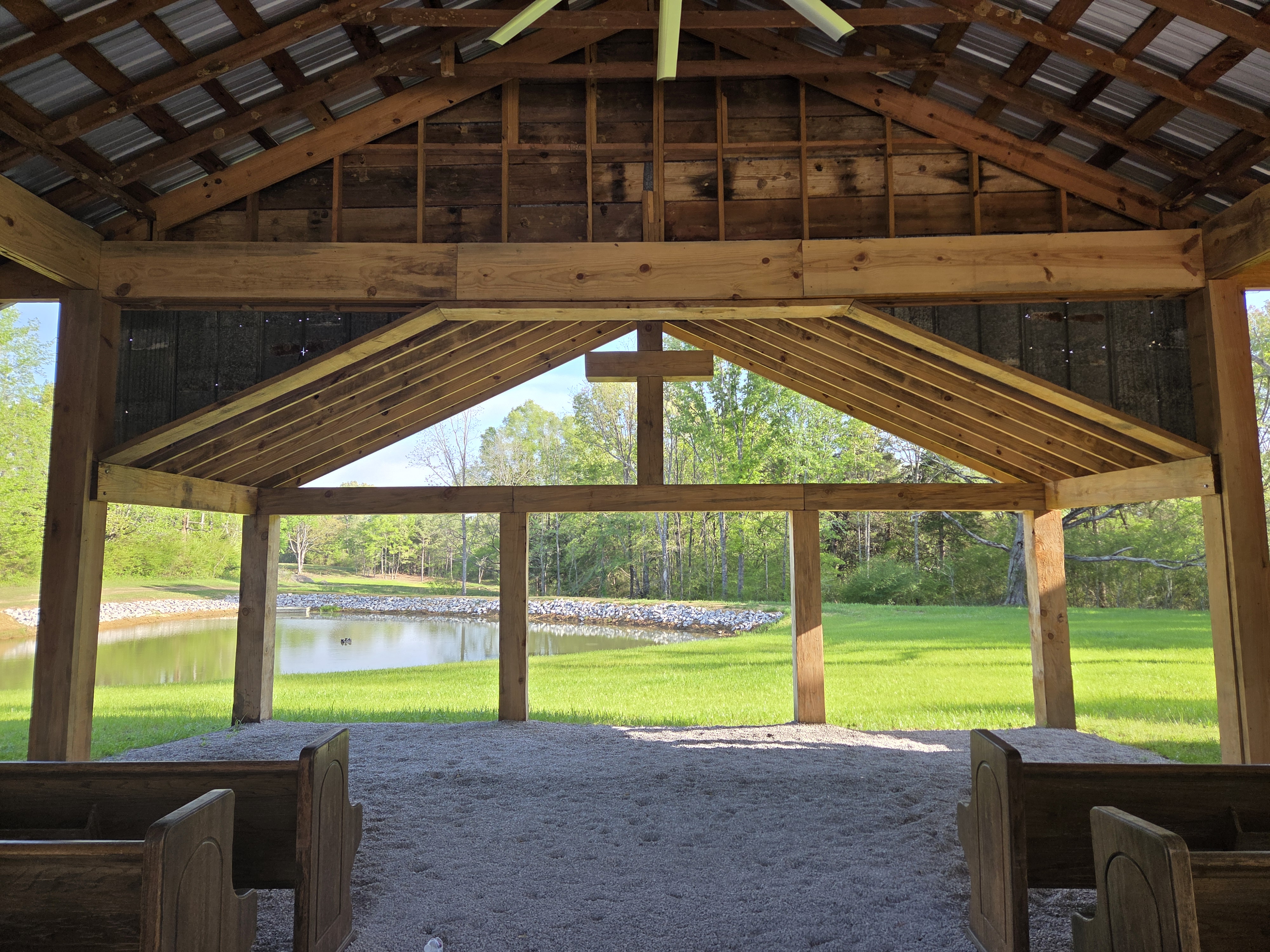 Open-air chapel overlooking the pond and tree line